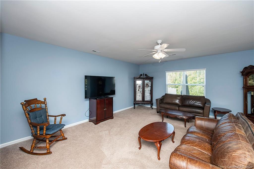 9915 Paper Tree Road Charlotte, NC 28227 - Photo 6 of 35 a living room with furniture and a flat screen tv