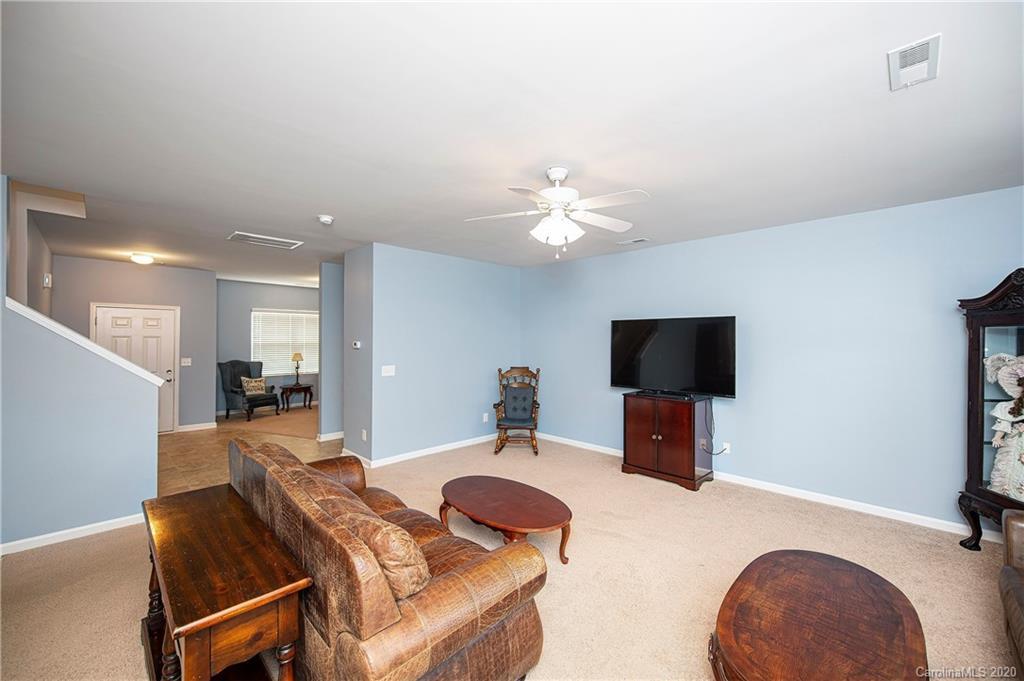 9915 Paper Tree Road Charlotte, NC 28227 - Photo 8 of 35 a living room with furniture and a flat screen tv