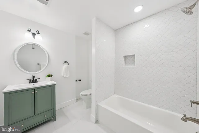 a bathroom with a sink a toilet and bathtub