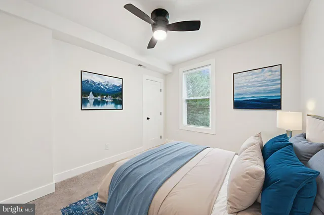 a bedroom with a bed and a painting on the wall