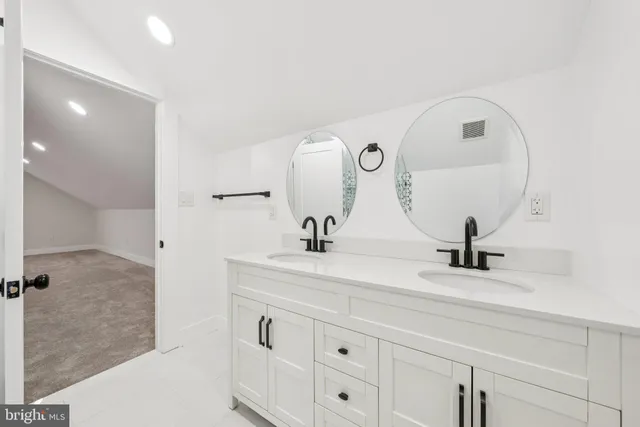 a bathroom with a sink vanity and a mirror