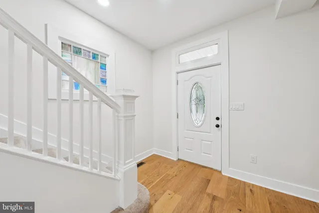 a view of front door with hallway and stairs