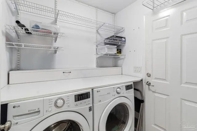 a view of washer and dryer with kitchen in the background
