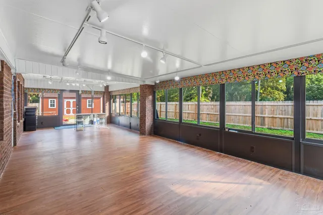 a view of a yard in front of a house with a large tree