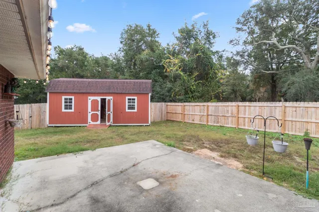 a view of a backyard with a garden and deck