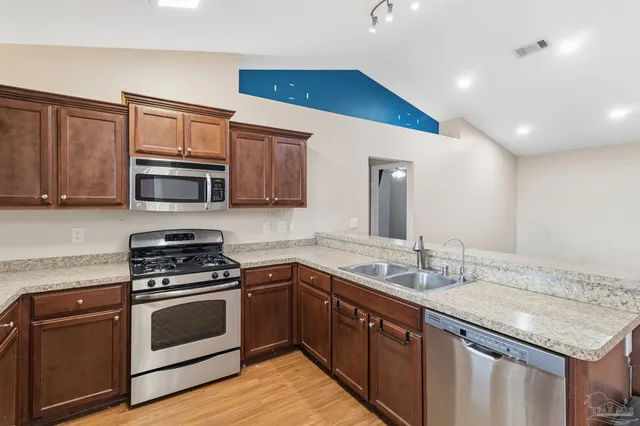 a kitchen with a sink stove and microwave