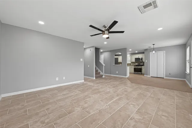 an empty room with a empty space and a ceiling fan