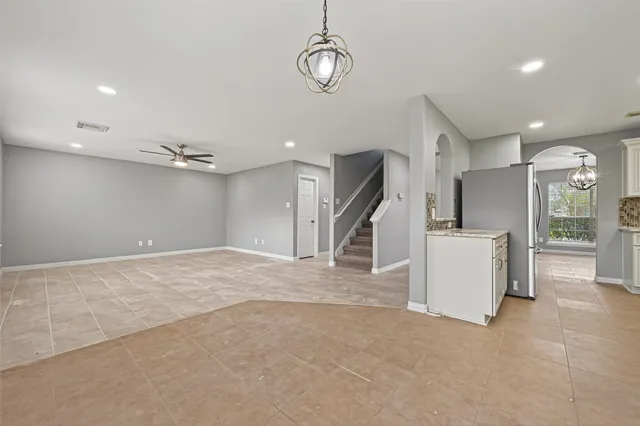 a view of an empty room with kitchen appliances