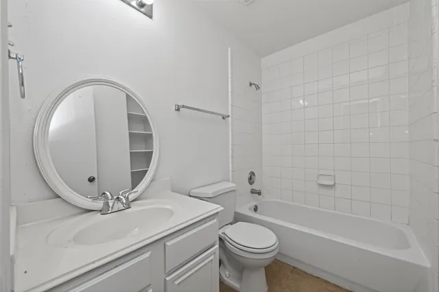 an empty room with a ceiling fan and window