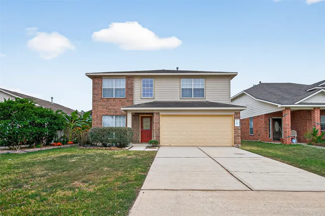 a front view of house with yard and trees