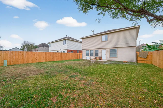 a view of a backyard with a garden and deck
