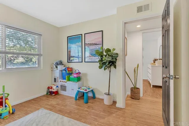 a view of a room with wooden floor and windows