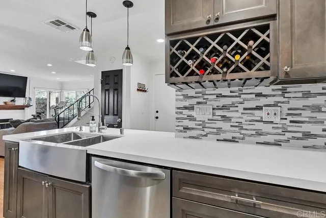 a kitchen with a sink a stove and a microwave