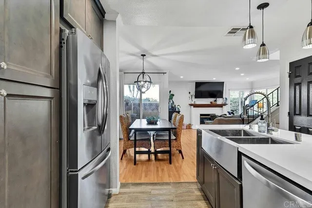 a kitchen with stainless steel appliances a refrigerator and a stove top oven