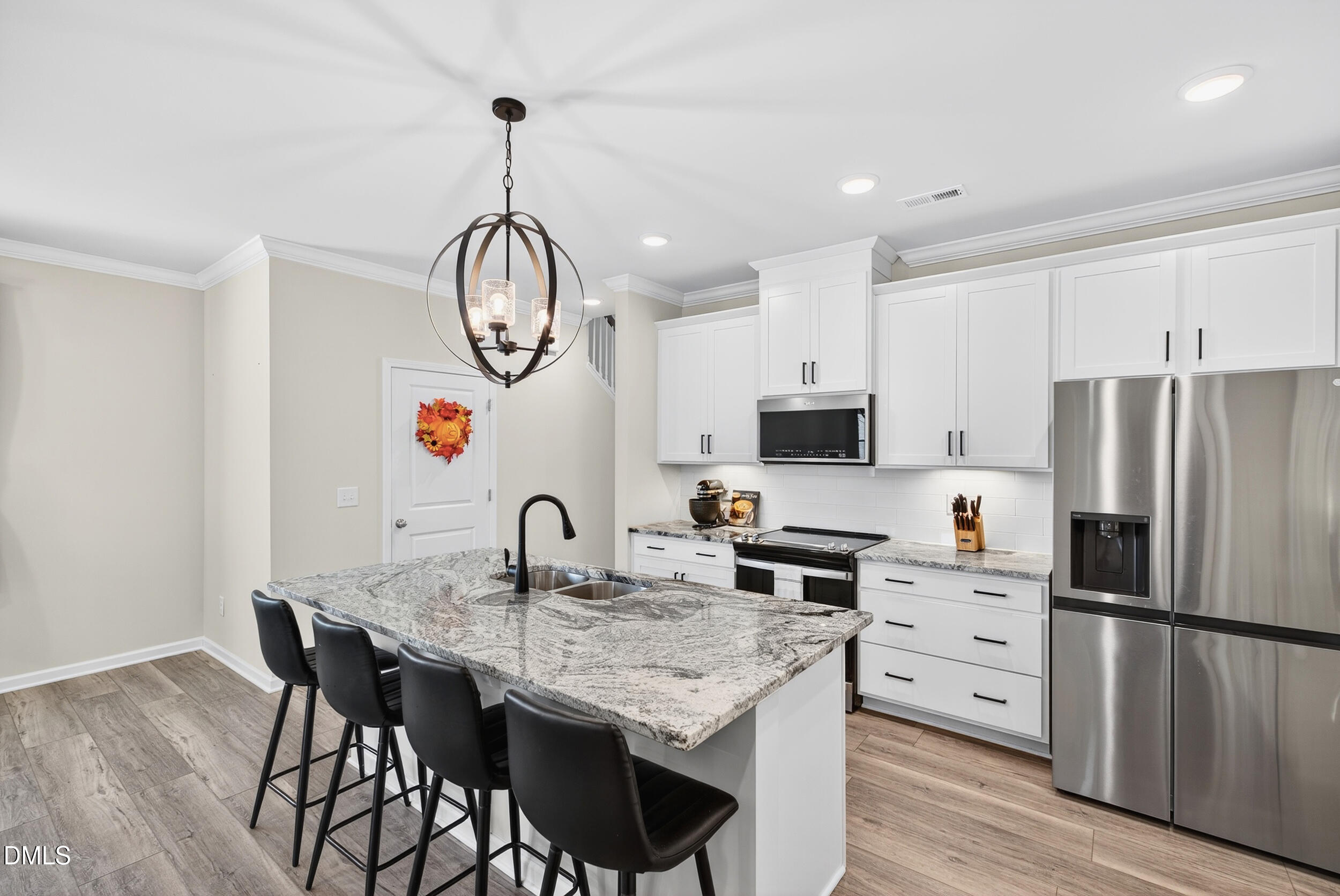 143 Umbrella Way Garner, NC 27529 - Photo 10 of 31 a kitchen with granite countertop a table chairs stove and refrigerator