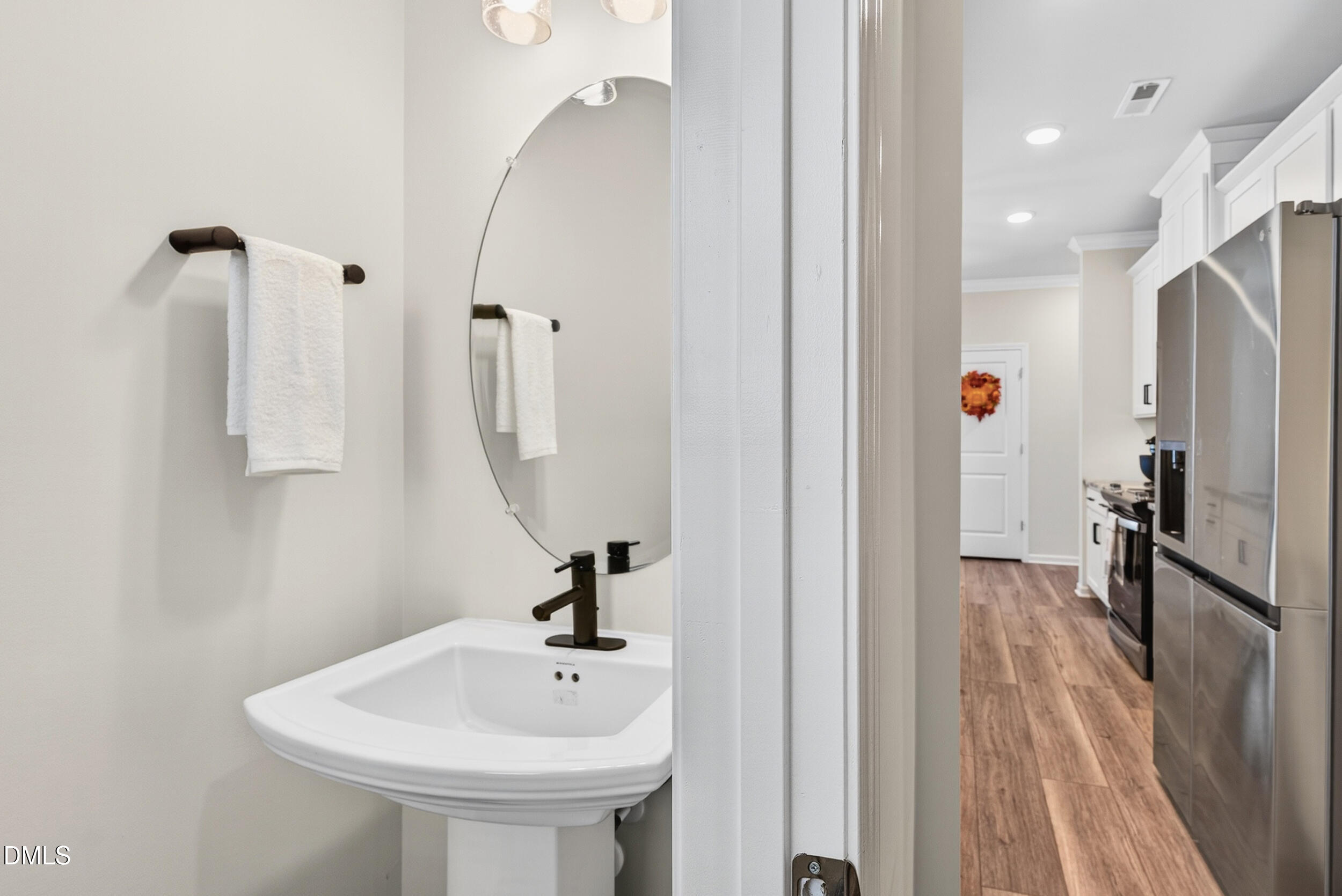 143 Umbrella Way Garner, NC 27529 - Photo 16 of 31 a bathroom with a sink a mirror and shower