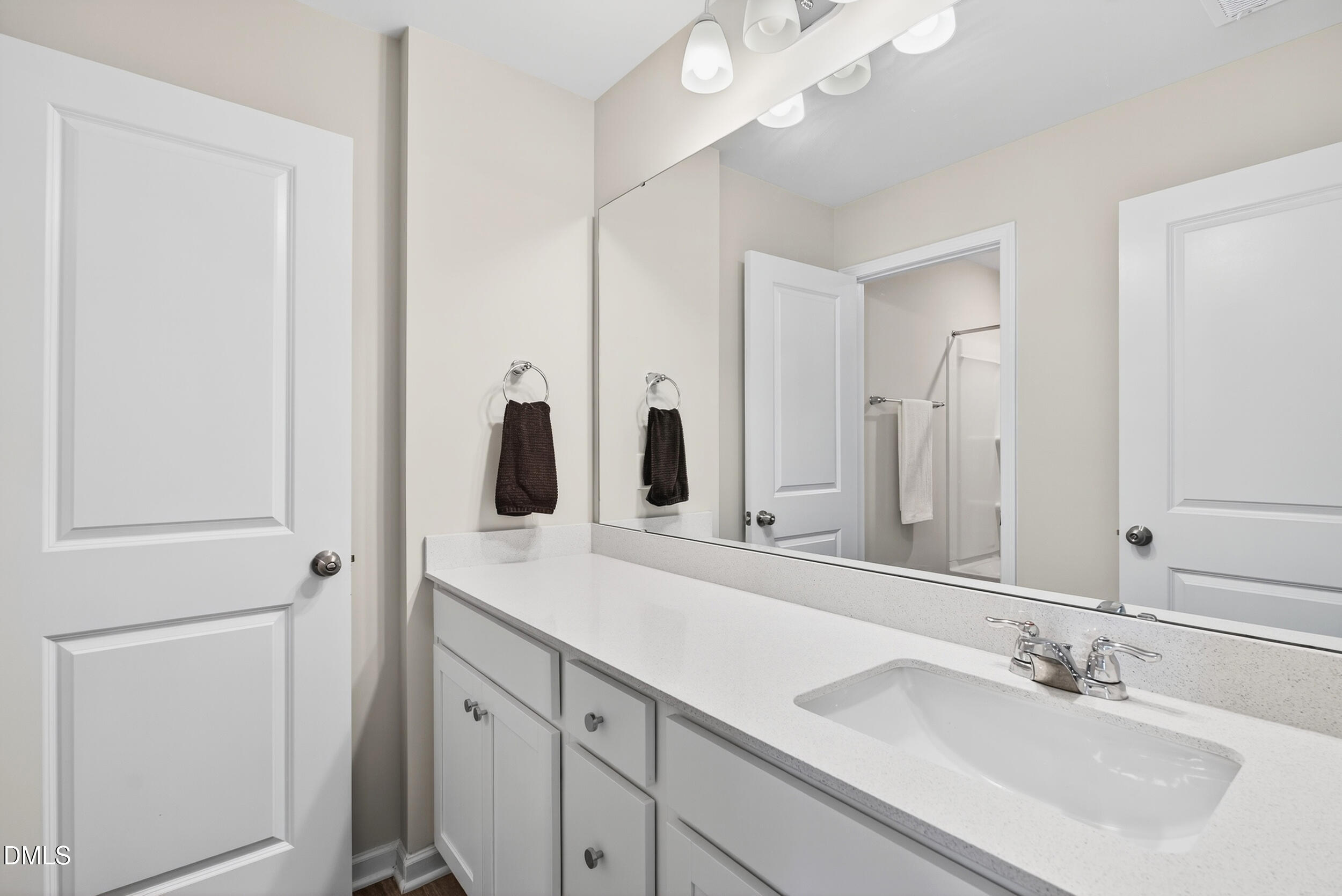 143 Umbrella Way Garner, NC 27529 - Photo 25 of 31 a bathroom with a double vanity sink and mirror
