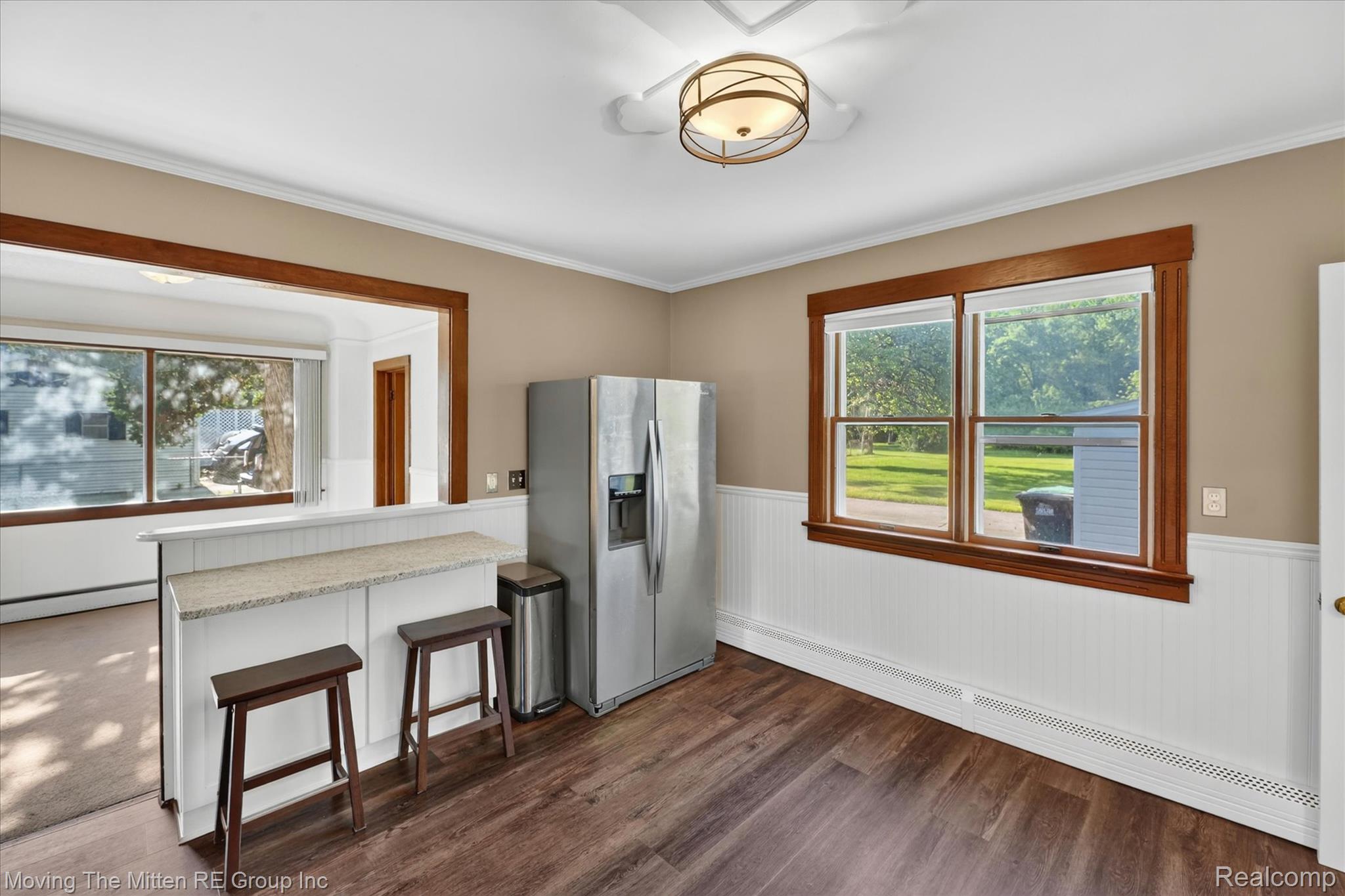 25505 Wick Road Taylor, MI 48180 - Photo 22 of 68 Kitchen with wainscoting, stainless steel fridge, a baseboard heating unit, a peninsula, and dark wood finished floors