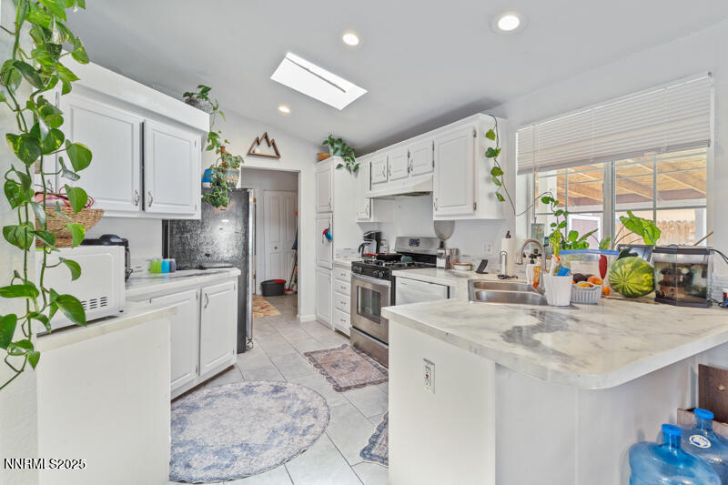 1358 Leopard Street Reno, NV 89506 - Photo 8 of 20 a kitchen with sink refrigerator and microwave