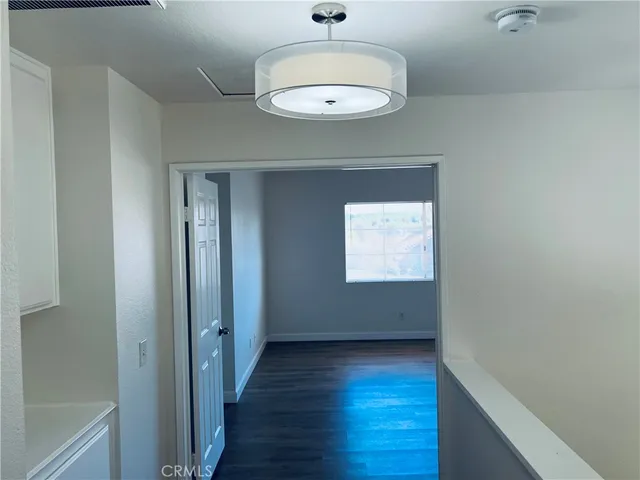 a view of hallway with wooden floor