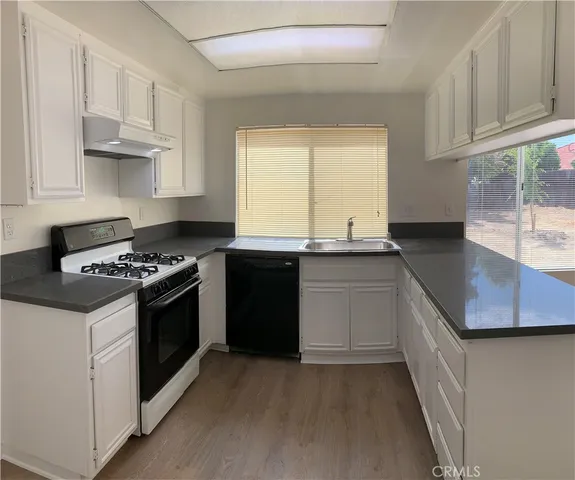 a kitchen with stainless steel appliances granite countertop a sink and a stove