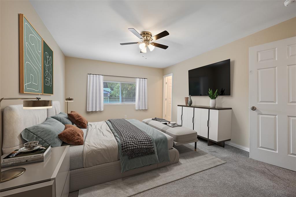 7318 Emory Oak Lane Dallas, TX 75249 - Photo 6 of 28 Carpeted bedroom featuring a window with white curtains, a ceiling fan with light fixture, and a paneled interior door