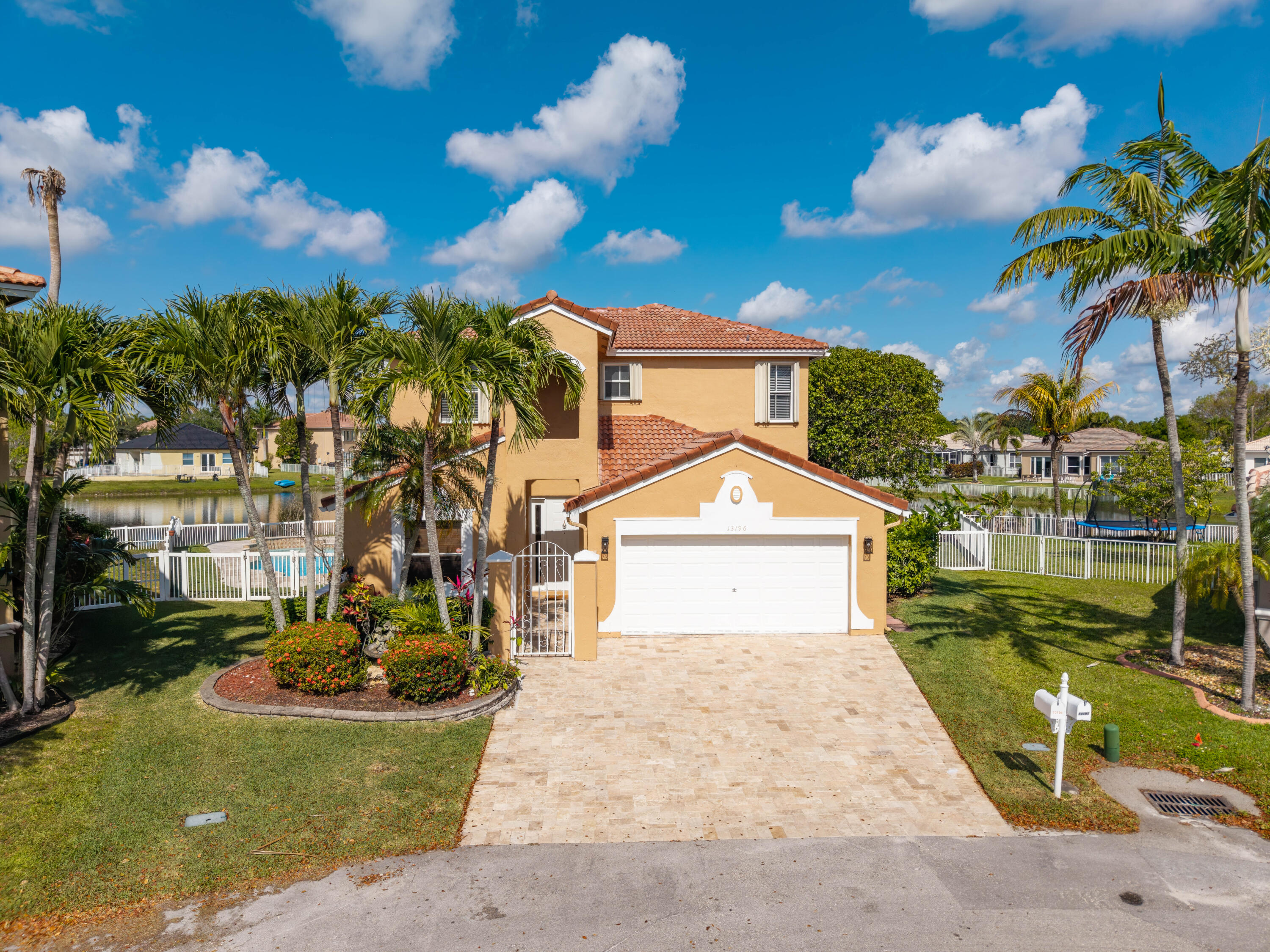 13196 Southwest 29th Street Miramar, FL 33027 - Photo 16 of 71 a view of a white house with a yard and potted plants
