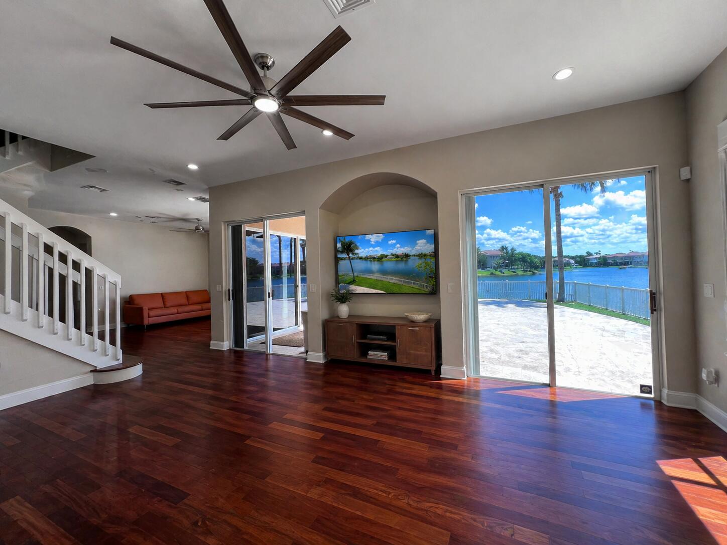 13196 Southwest 29th Street Miramar, FL 33027 - Photo 47 of 71 an empty room with wooden floor a ceiling fan and a fireplace