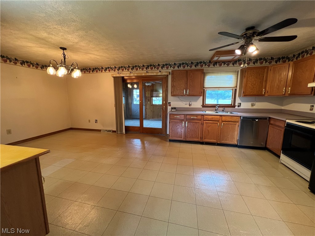 9066 Crow Road Litchfield, OH 44253 - Photo 16 of 28 Kitchen featuring sink, pendant lighting, stainless steel dishwasher, ceiling fan with notable chandelier, and electric stove