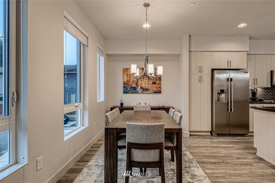 17905 35th Avenue Southeast, Unit A3 Bothell, WA 98012 - Photo 12 of 35 a kitchen with refrigerator and dining table