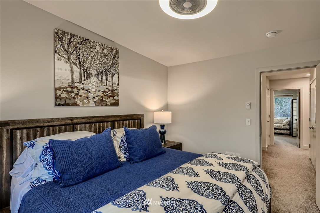 17905 35th Avenue Southeast, Unit A3 Bothell, WA 98012 - Photo 16 of 35 a bedroom with a bed and a lamp on dresser