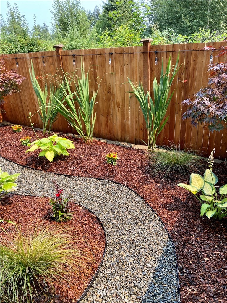 17905 35th Avenue Southeast, Unit A3 Bothell, WA 98012 - Photo 26 of 35 a view of a wooden floor with a flower in a garden