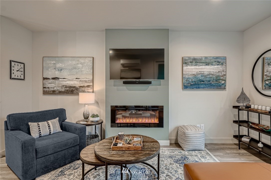 17905 35th Avenue Southeast, Unit A3 Bothell, WA 98012 - Photo 5 of 35 a living room with furniture a rug and wall paintings