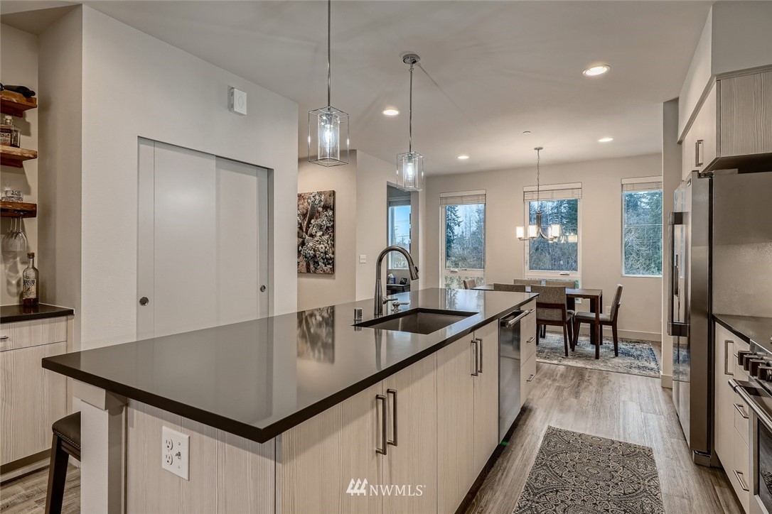 17905 35th Avenue Southeast, Unit A3 Bothell, WA 98012 - Photo 8 of 35 a kitchen with kitchen island a counter top space a sink stainless steel appliances and cabinets