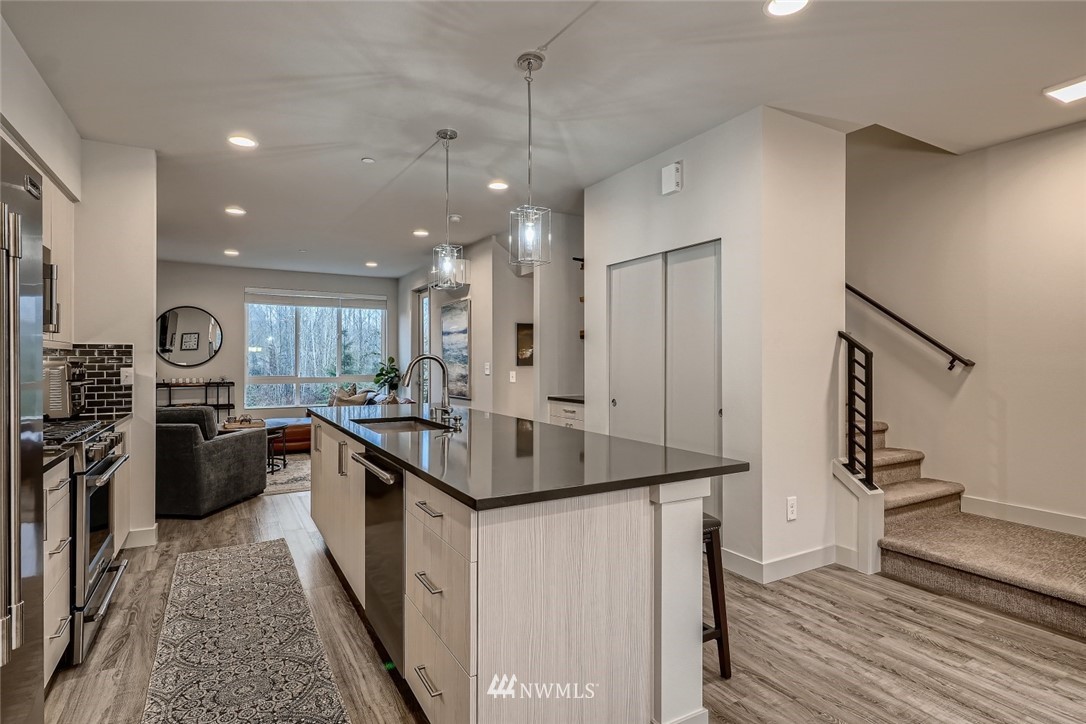 17905 35th Avenue Southeast, Unit A3 Bothell, WA 98012 - Photo 9 of 35 a kitchen with stainless steel appliances granite countertop a sink stove and refrigerator