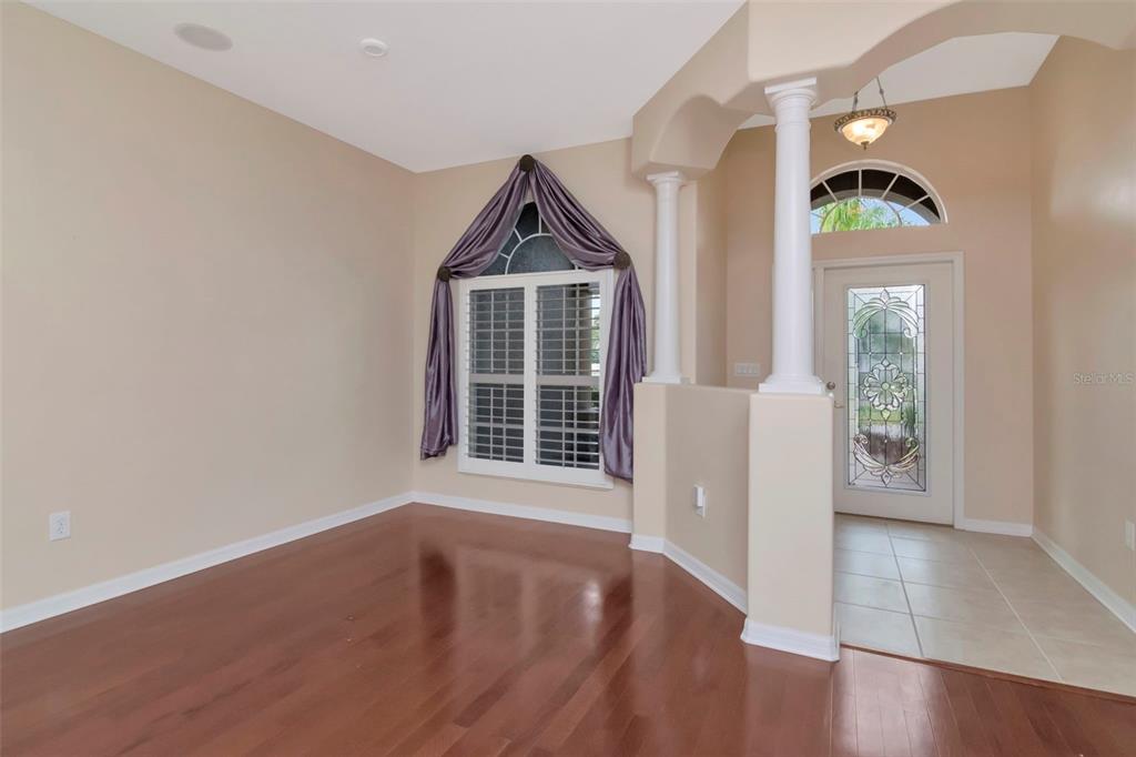 1835 Regal Mist Loop Trinity, FL 34655 - Photo 11 of 55 an entryway with wooden floor and windows