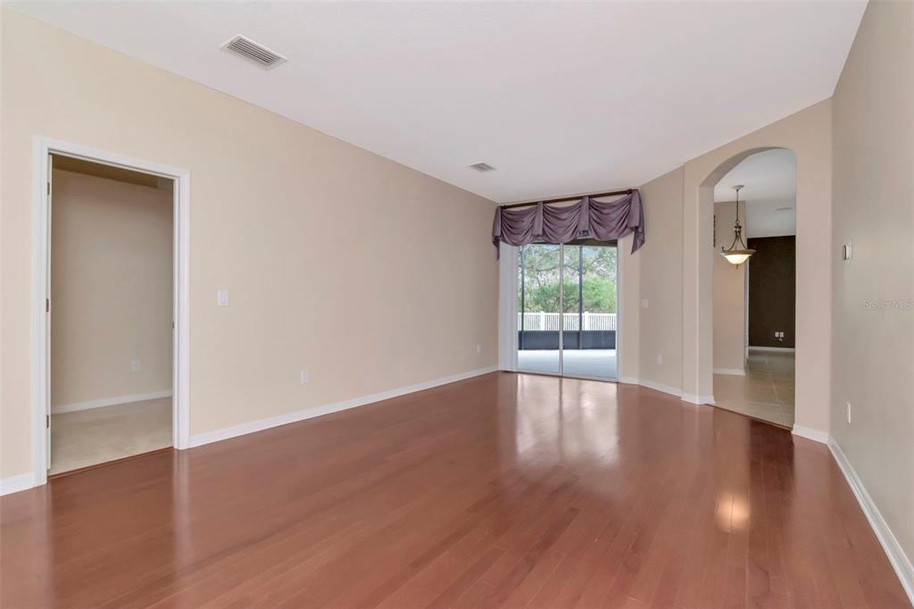 1835 Regal Mist Loop Trinity, FL 34655 - Photo 12 of 55 a view of an empty room with wooden floor and a window