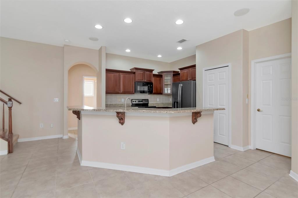 1835 Regal Mist Loop Trinity, FL 34655 - Photo 21 of 55 a view of kitchen with stainless steel appliances granite countertop a refrigerator and a stove top oven
