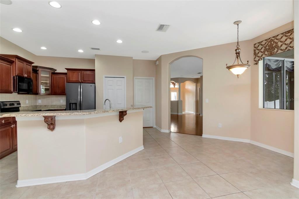 1835 Regal Mist Loop Trinity, FL 34655 - Photo 23 of 55 a large white kitchen with a refrigerator a sink and a stove