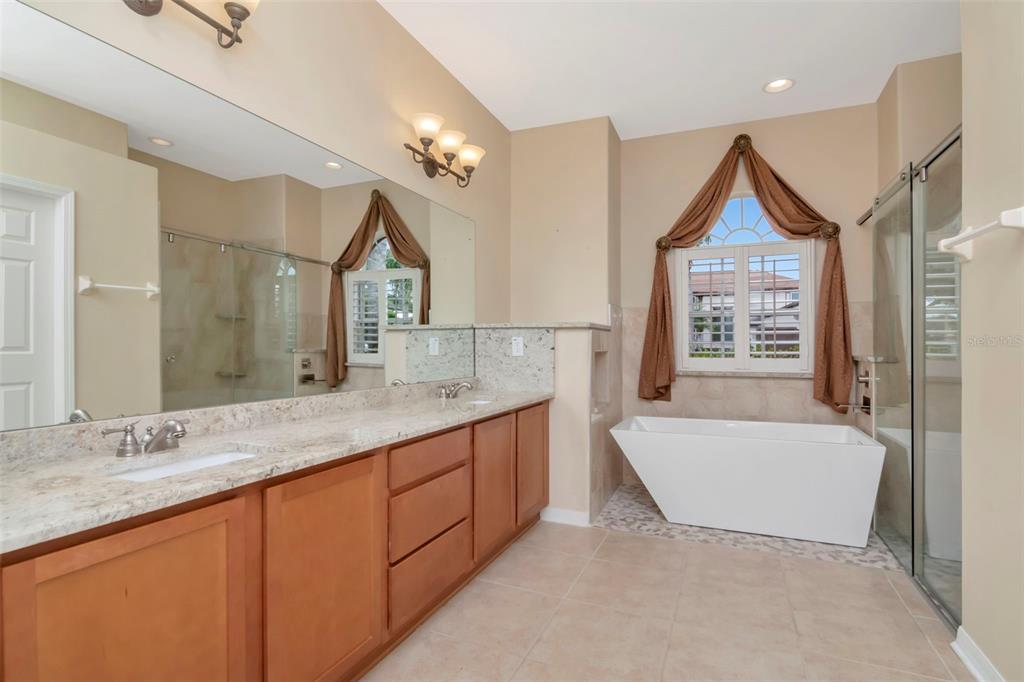 1835 Regal Mist Loop Trinity, FL 34655 - Photo 32 of 55 a spacious bathroom with a sink a mirror and a bathtub