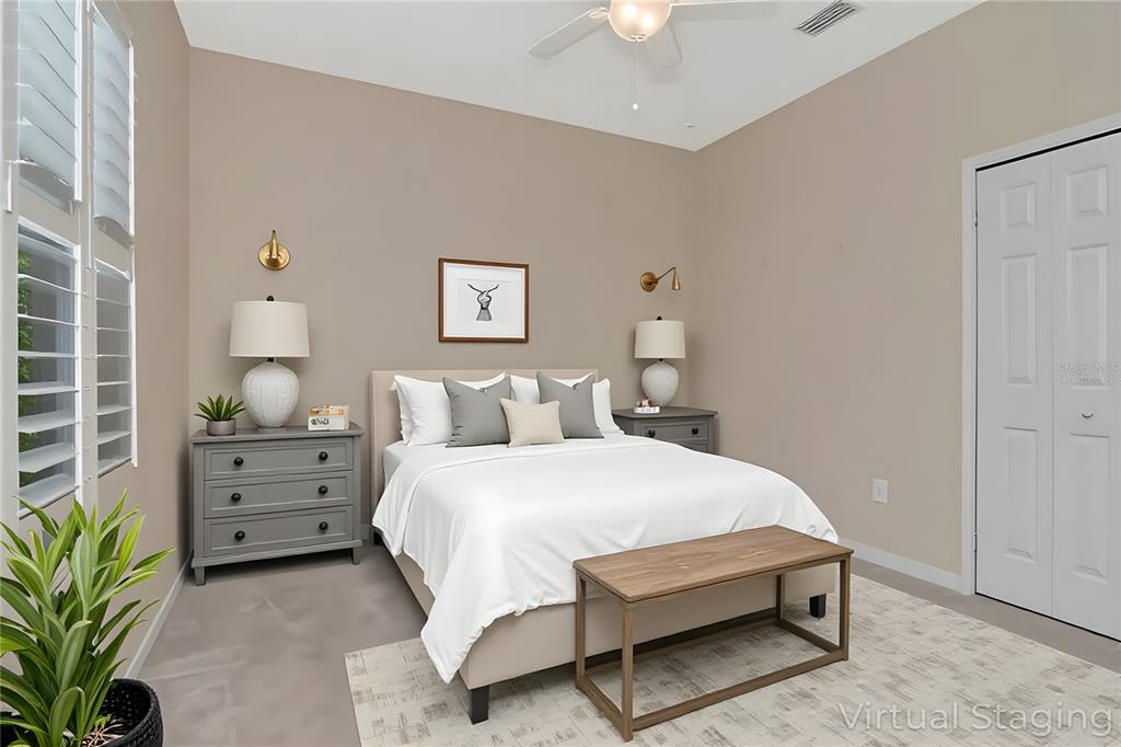 1835 Regal Mist Loop Trinity, FL 34655 - Photo 35 of 55 a bedroom with a bed potted plant on dresser and a chandelier