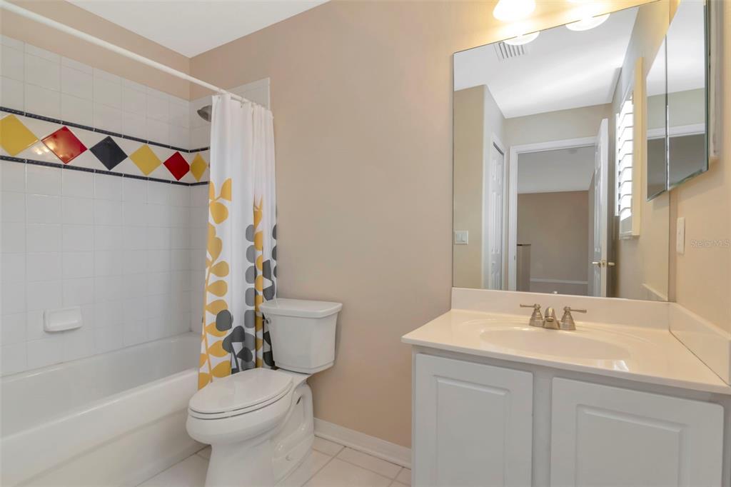 1835 Regal Mist Loop Trinity, FL 34655 - Photo 44 of 55 a bathroom with a sink a toilet and shower curtain