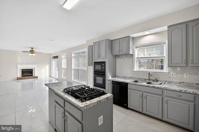 a kitchen with a sink stove top oven and refrigerator