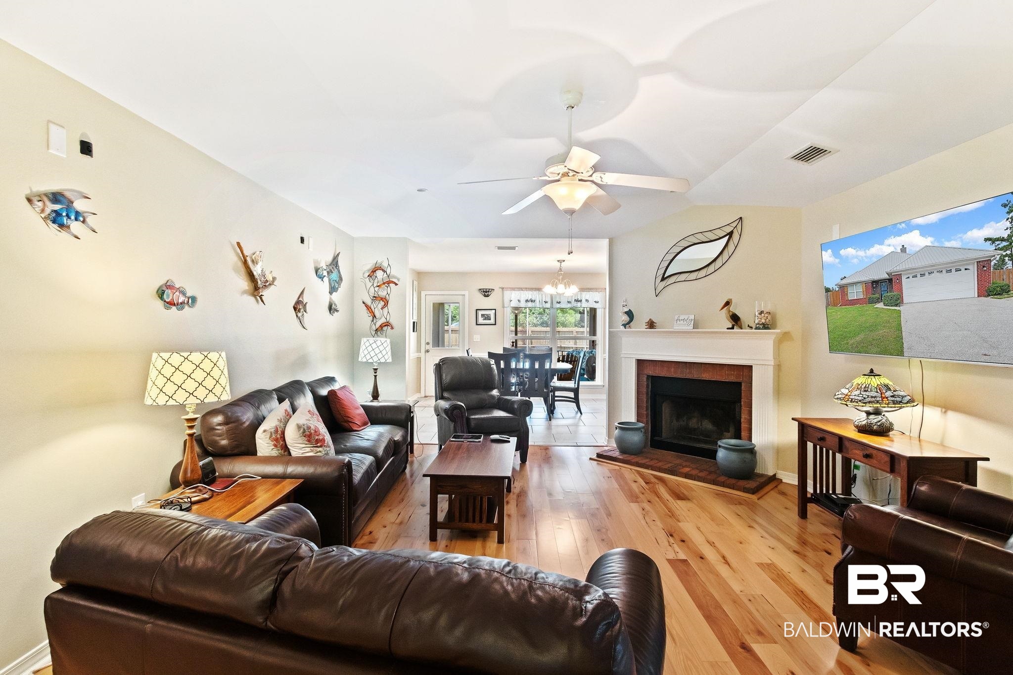 16898 Sugar Loop Foley, AL 36535 - Photo 11 of 67 Living room featuring a fireplace, ceiling fan with notable chandelier, and light hardwood / wood-style floors