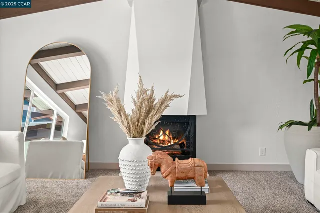 a living room with furniture fireplace and a table