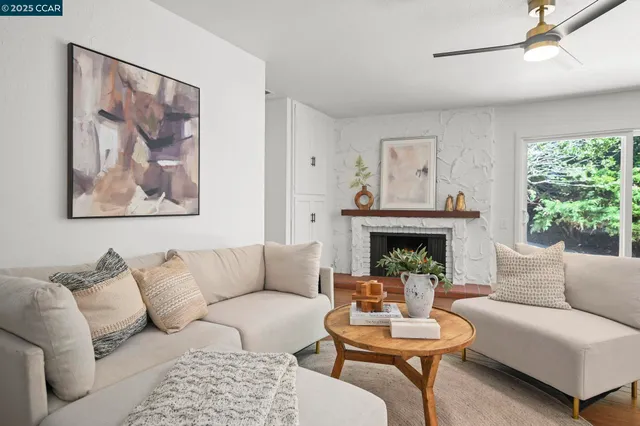 a living room with furniture and a fireplace