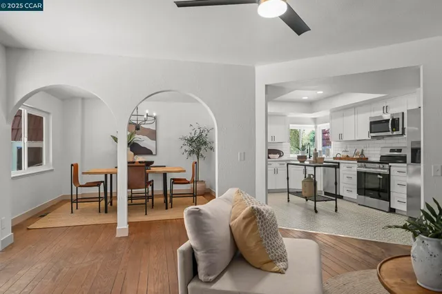 a kitchen with stainless steel appliances a stove a sink a refrigerator a center island and a refrigerator