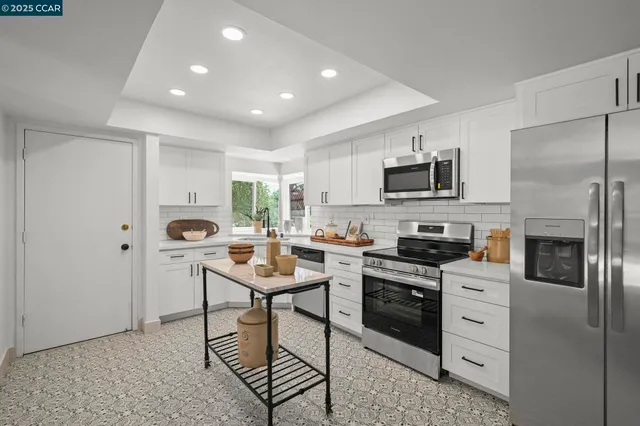 a kitchen with a sink a microwave and cabinets