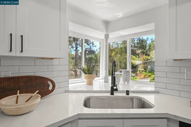a kitchen with a sink and a stove
