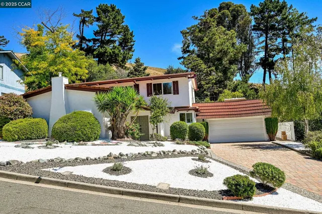 a view of a house with a yard and plants